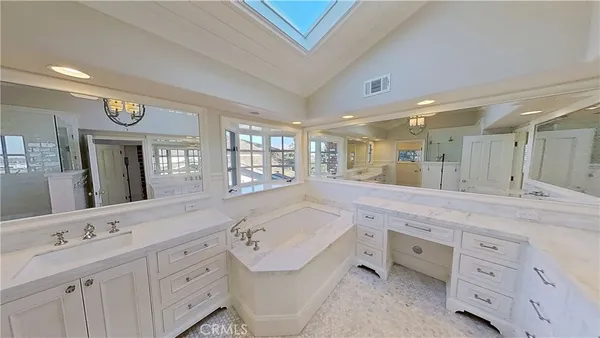 a spacious bathroom with a double vanity sink a mirror and a shower