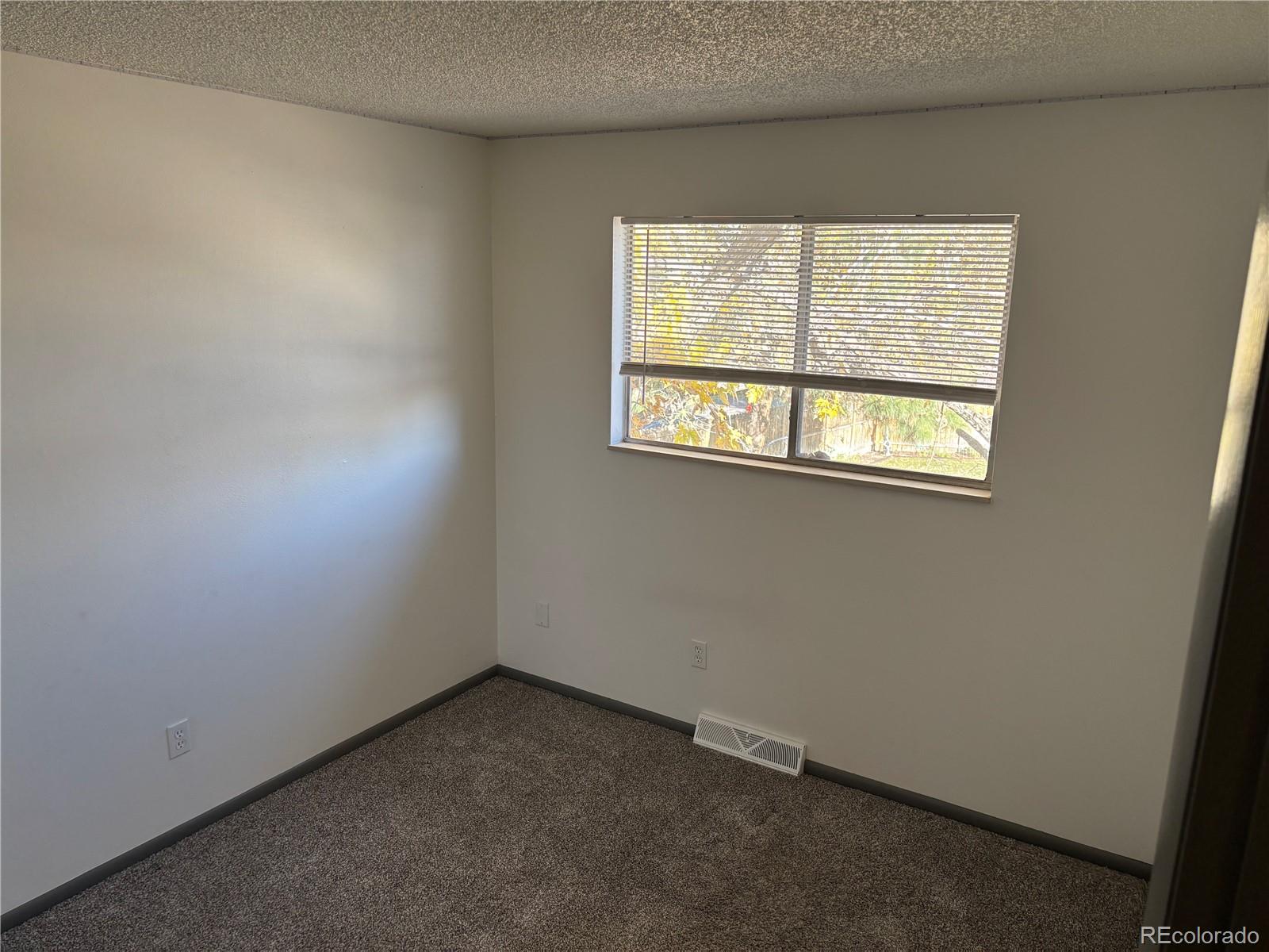 9162 Cody Street Broomfield, CO 80021 - Photo 11 of 29 an empty room with a window
