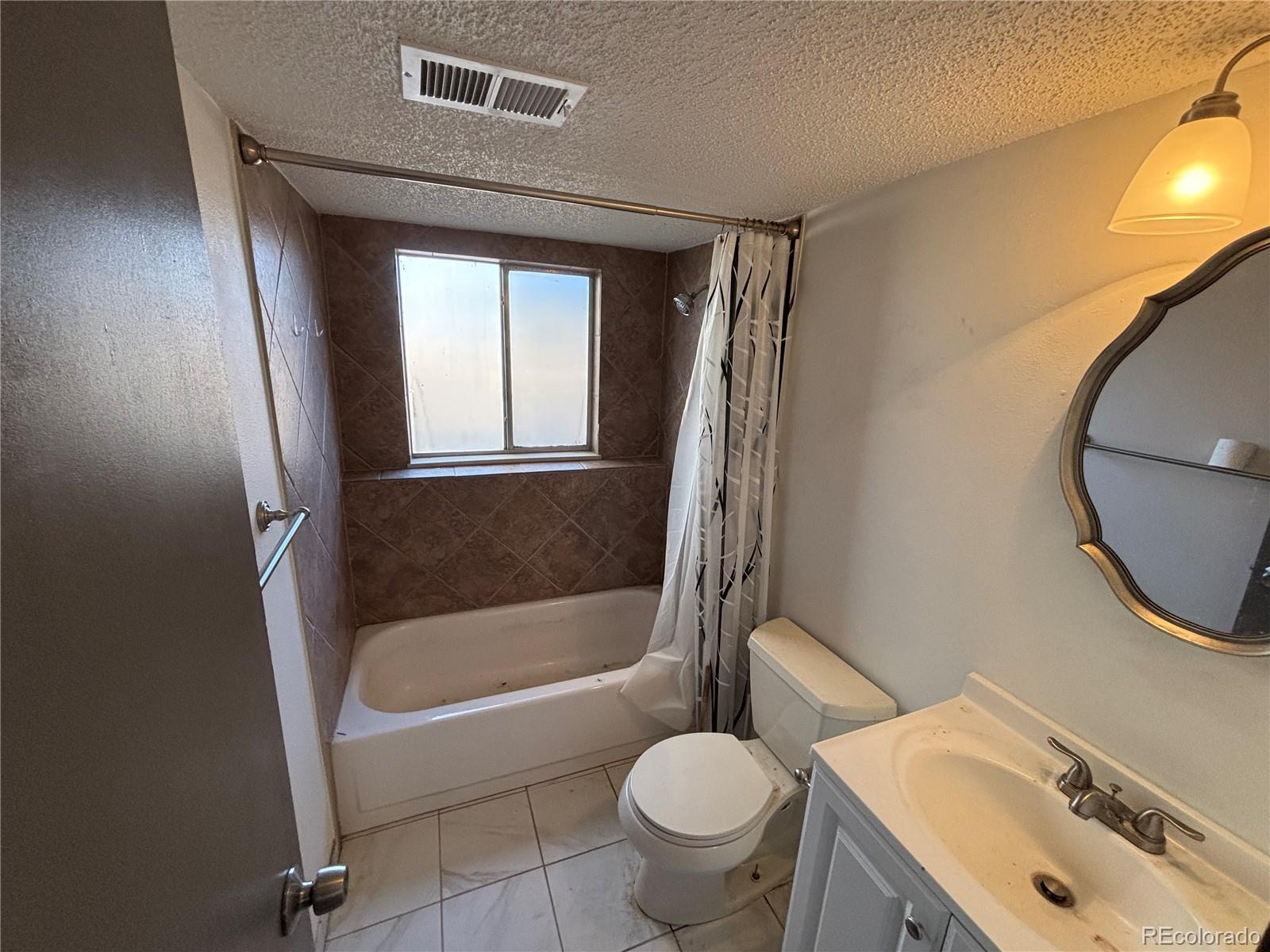 9162 Cody Street Broomfield, CO 80021 - Photo 14 of 29 a bathroom with a sink toilet and shower