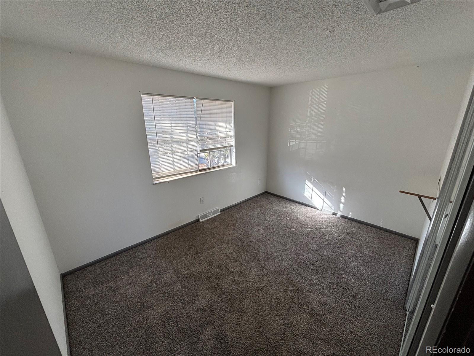 9162 Cody Street Broomfield, CO 80021 - Photo 16 of 29 an empty room with windows
