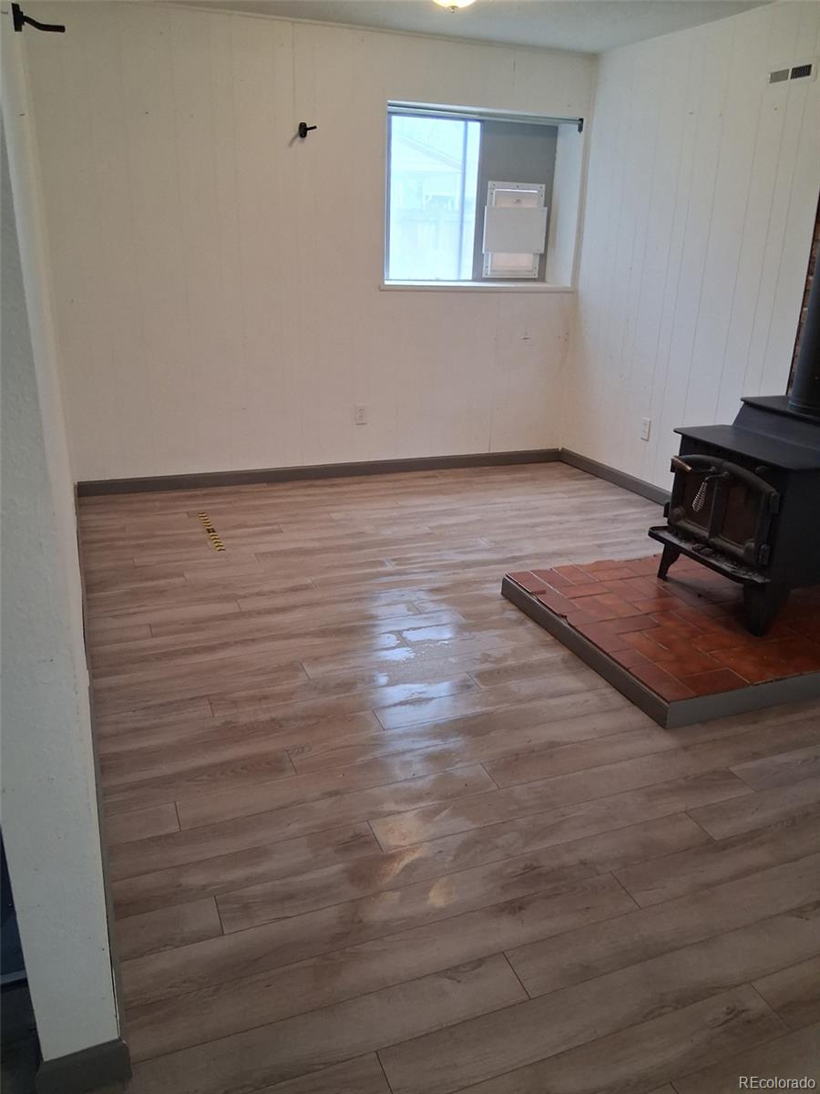 9162 Cody Street Broomfield, CO 80021 - Photo 19 of 29 a view of a room with wooden floor and a window