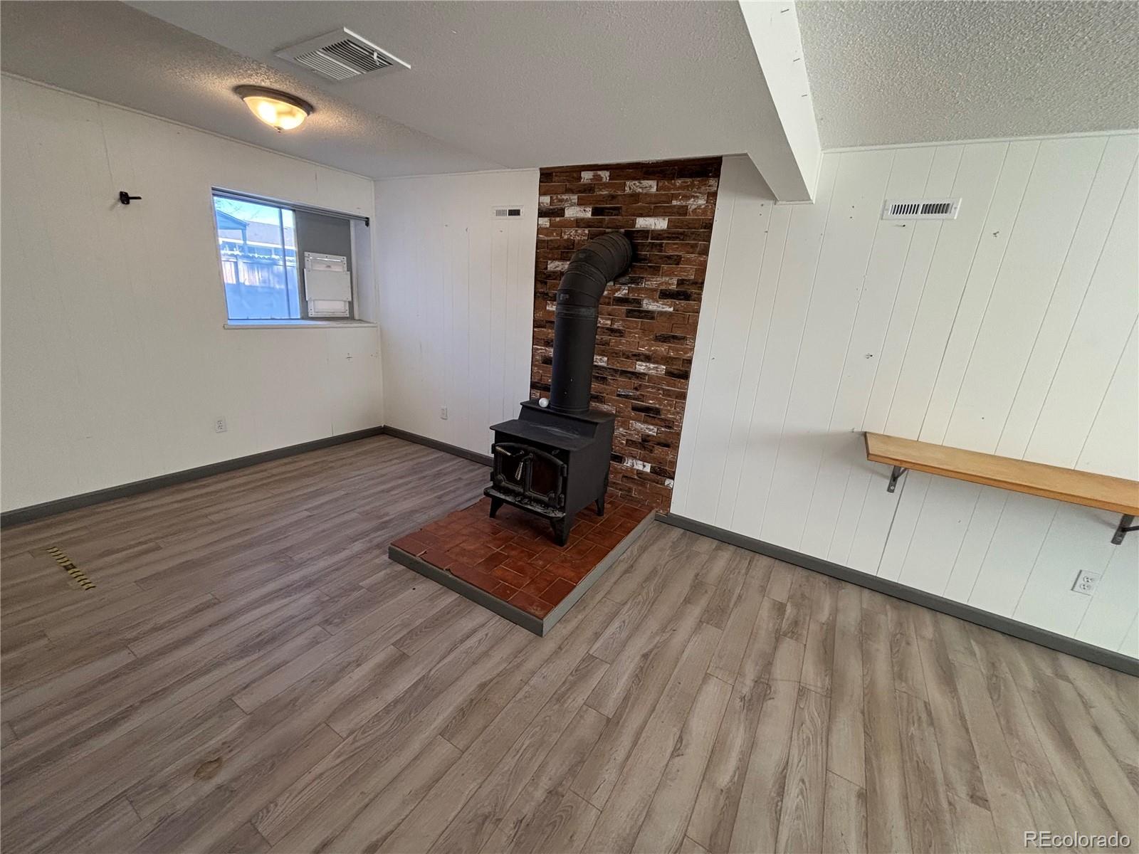 9162 Cody Street Broomfield, CO 80021 - Photo 20 of 29 wooden floor in a hall with an empty room