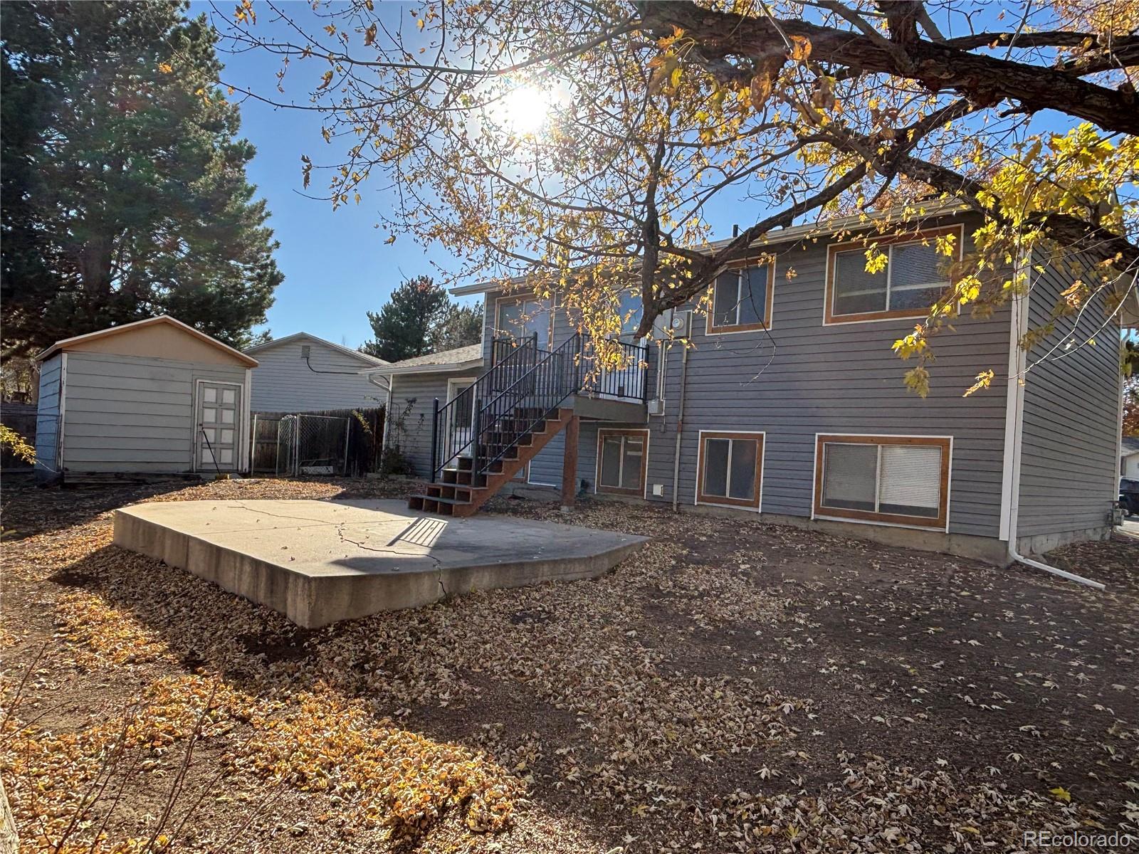 9162 Cody Street Broomfield, CO 80021 - Photo 25 of 29 a front view of a house with a yard and garage