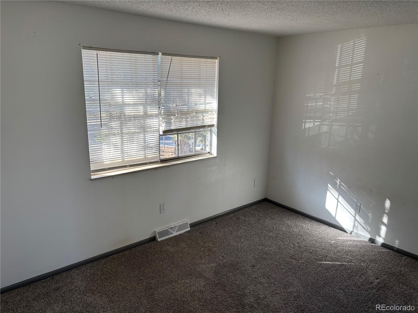 9162 Cody Street Broomfield, CO 80021 - Photo 10 of 29 an empty room with a window