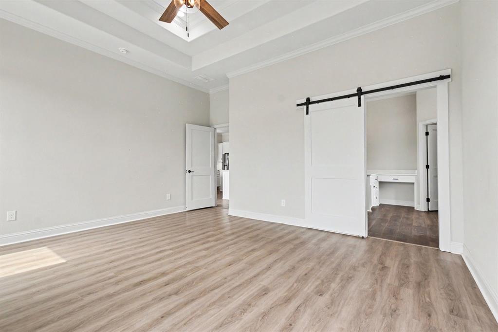 530 P R 491 Leonard, TX 75452 - Photo 16 of 35 Spacious room featuring wood-finish flooring, a tray ceiling with crown molding, and a ceiling fan