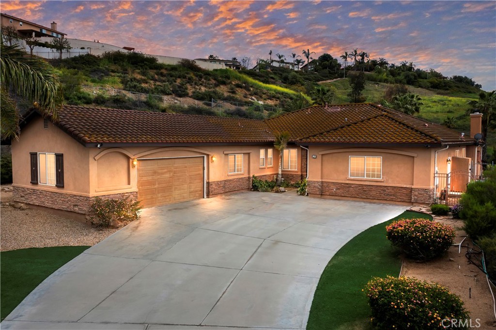 a view of a house with a garden and pathway