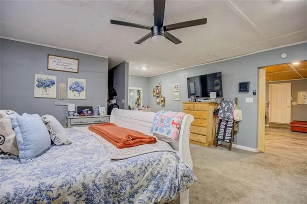a bed room with a bed window and a flat screen tv