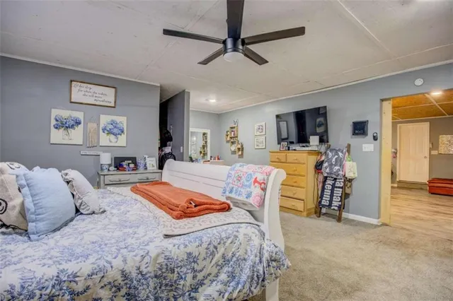 a bed room with a bed window and a flat screen tv