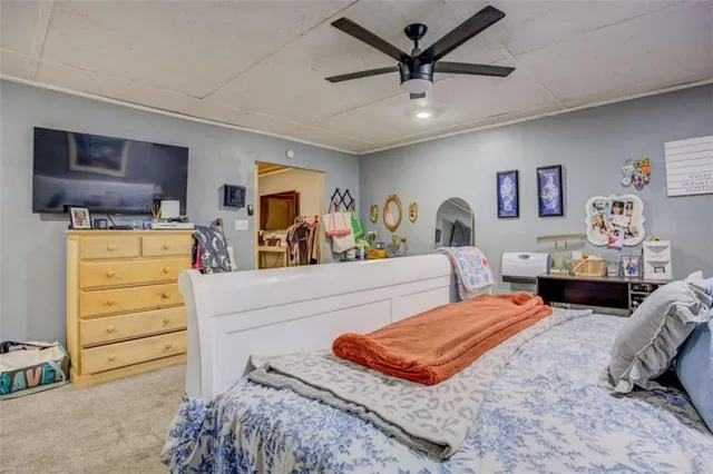 a bedroom with furniture and a flat screen tv