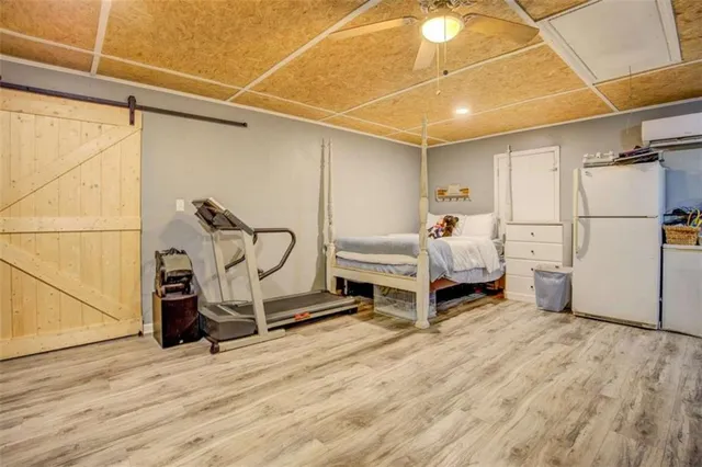 a living room with a walk in closet and gym equipment