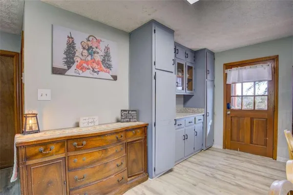 a spacious bathroom with a granite countertop sink and a mirror
