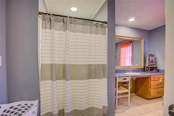 a bathroom with a shower and a sink