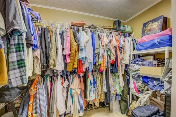 a view of walk in closet with clothes