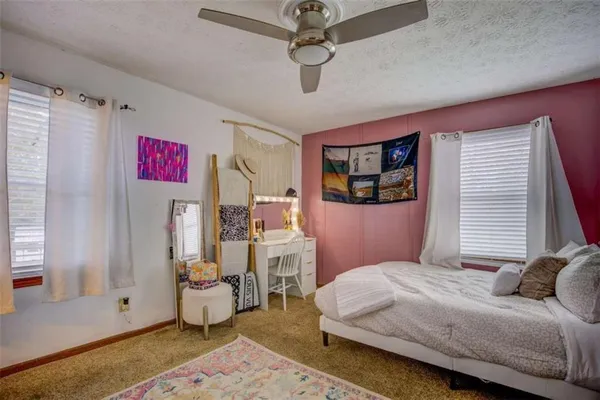 a bathroom with a sink vanity mirror and toilet