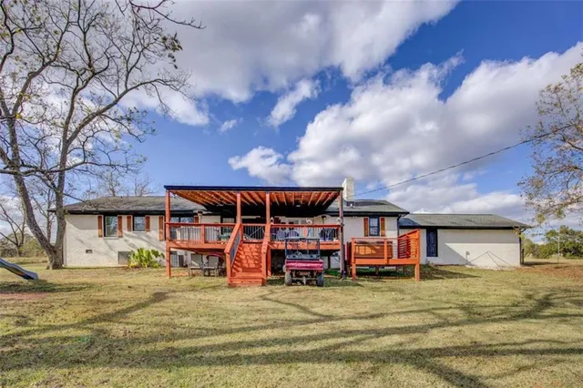 a view of a house with cars parked in front of it