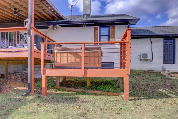 a view of a parking space with a large tree in front of it