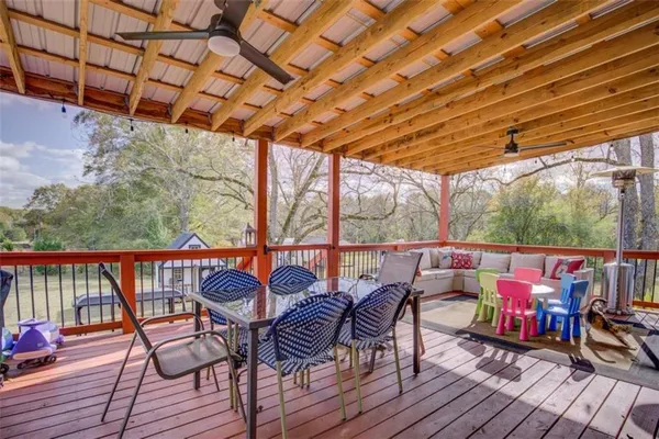 a outdoor dining space with furniture and wooden floor