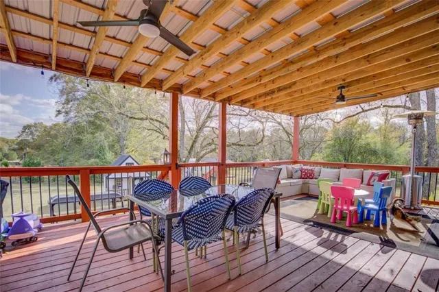 a outdoor dining space with furniture and wooden floor