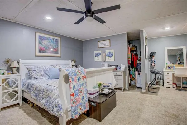 a bedroom with furniture and a flat screen tv