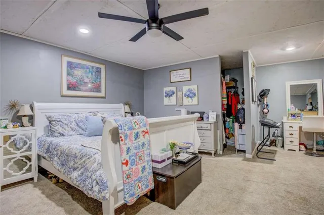 a bedroom with furniture and a flat screen tv