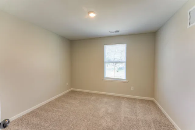 an empty room with closet area