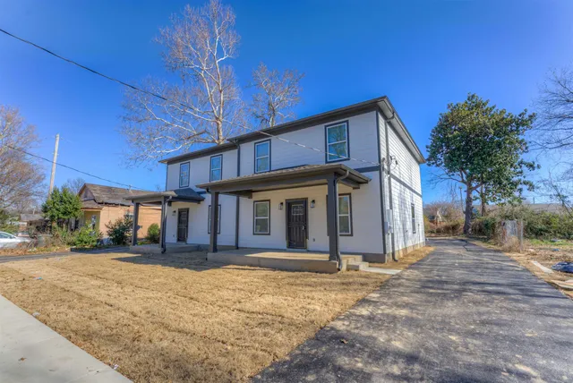 a view of a house with a garage and a fireplace