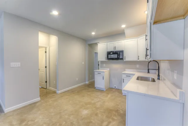 a kitchen with a stove top oven sink and cabinets
