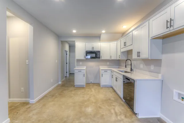 a kitchen with a sink cabinets and window