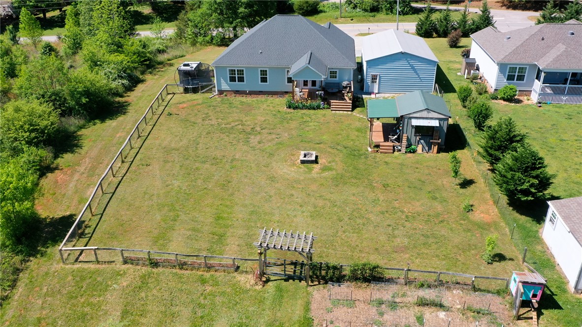 696 Mt Olivet Road Six Mile, SC 29682 - Photo 26 of 35 This expansive backyard offers ample green space for outdoor enjoyment and includes a dedicated gardening area.