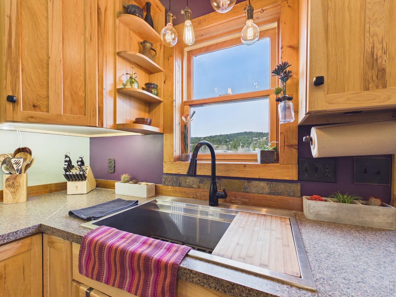 131 West Boulder Street Nederland, CO 80466 - Photo 9 of 46 Mountain views, farm-style sink, designer fixtures, shelving.