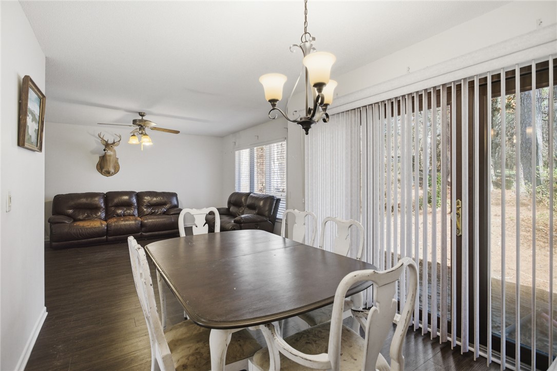 308 Wildwood Road Walhalla, SC 29691 - Photo 9 of 23 This inviting space features an elegant chandelier and rich wood flooring, ideal for gatherings.