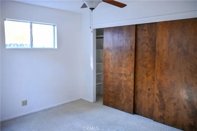 a view of a bedroom with a door and a chair