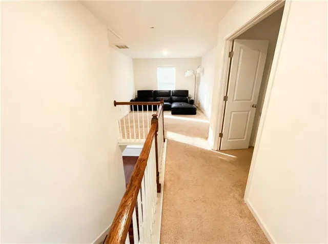 a living room with a couch and a potted plant