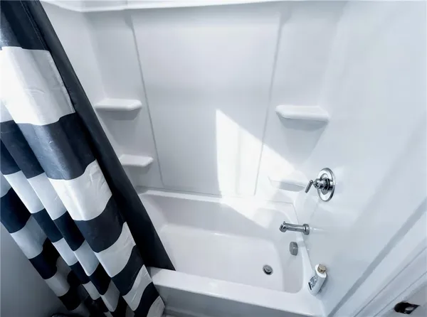 a bathroom with a shower and a toilet