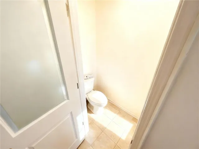a view of a kitchen with fridge and wooden floor