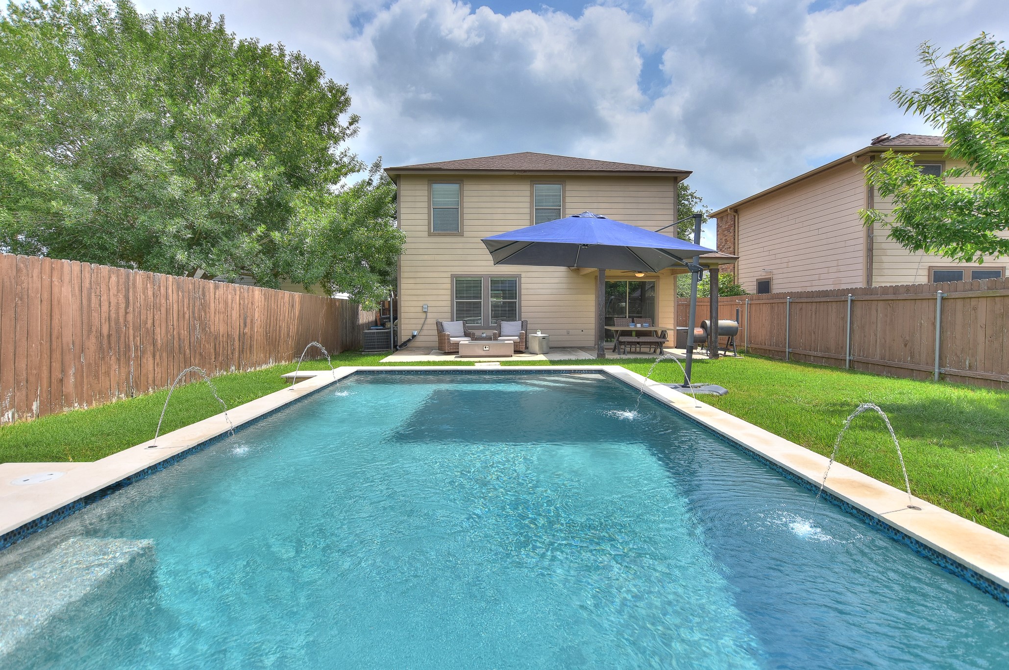 a view of a house with a yard patio and a small yard
