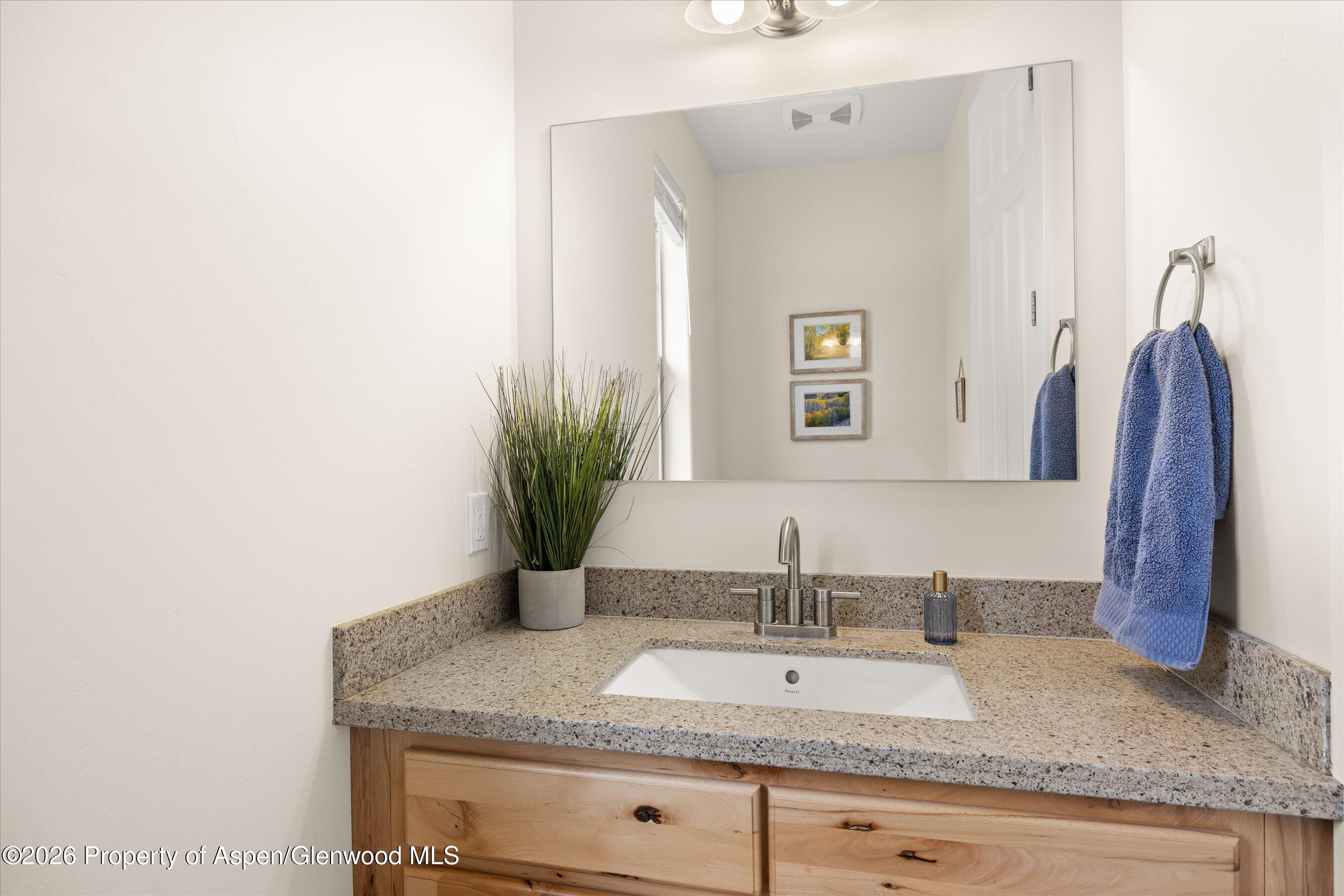 114 Redstone Drive New Castle, CO 81647 - Photo 11 of 20 a bathroom with a granite countertop sink and a mirror