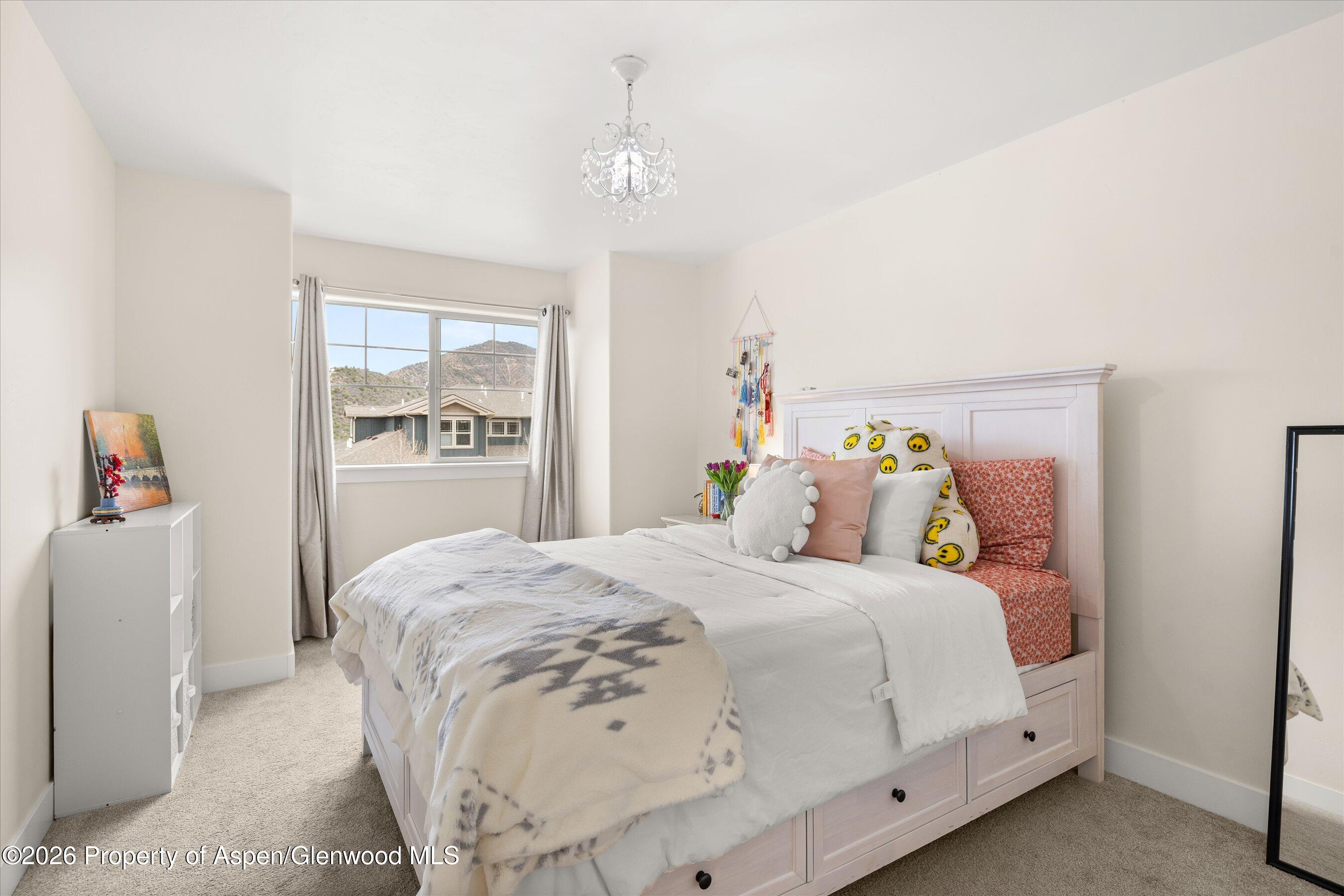 114 Redstone Drive New Castle, CO 81647 - Photo 13 of 20 a bedroom with a bed and a window