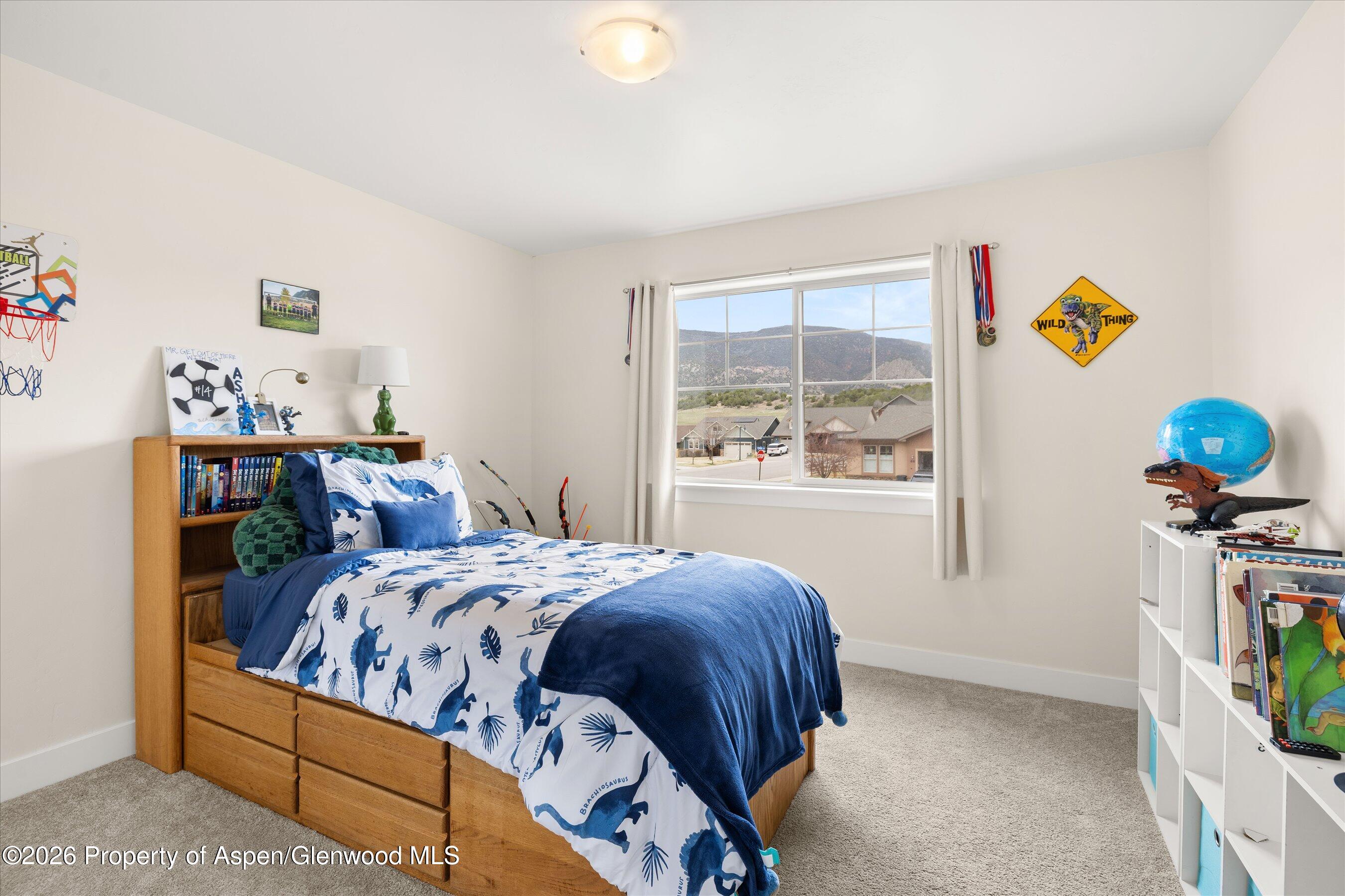 114 Redstone Drive New Castle, CO 81647 - Photo 15 of 20 a bedroom with a bed and a window