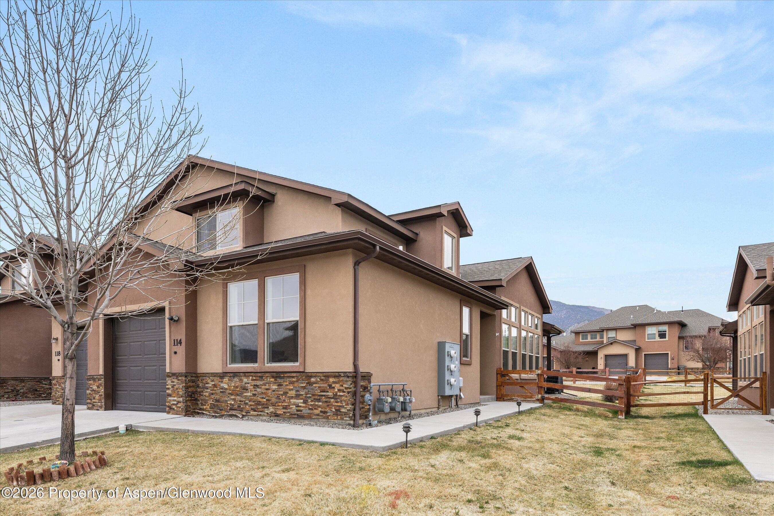 114 Redstone Drive New Castle, CO 81647 - Photo 19 of 20 a front view of a house with a yard covered with snow and trees