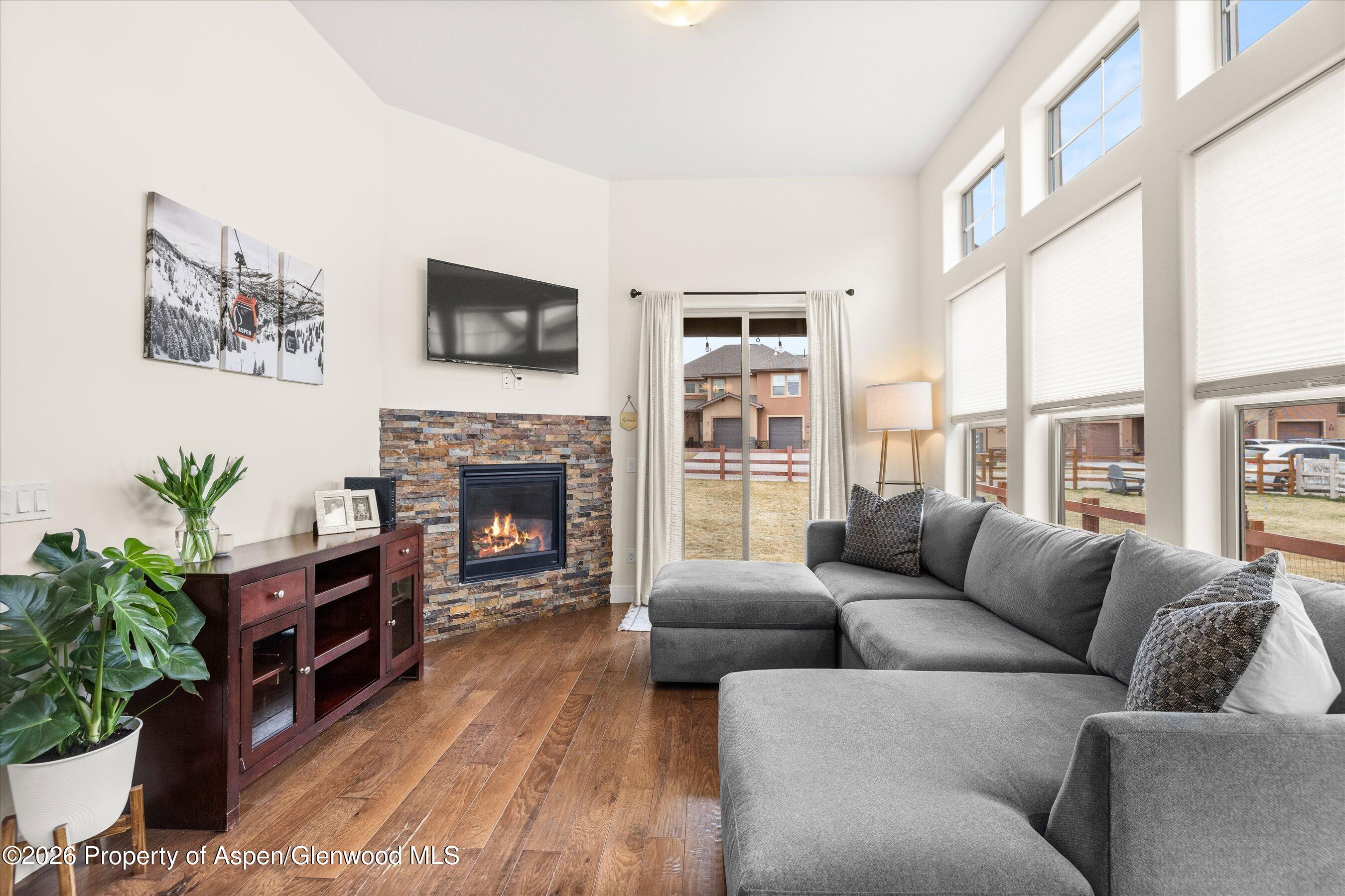 114 Redstone Drive New Castle, CO 81647 - Photo 3 of 20 a living room with furniture a flat screen tv and a fireplace