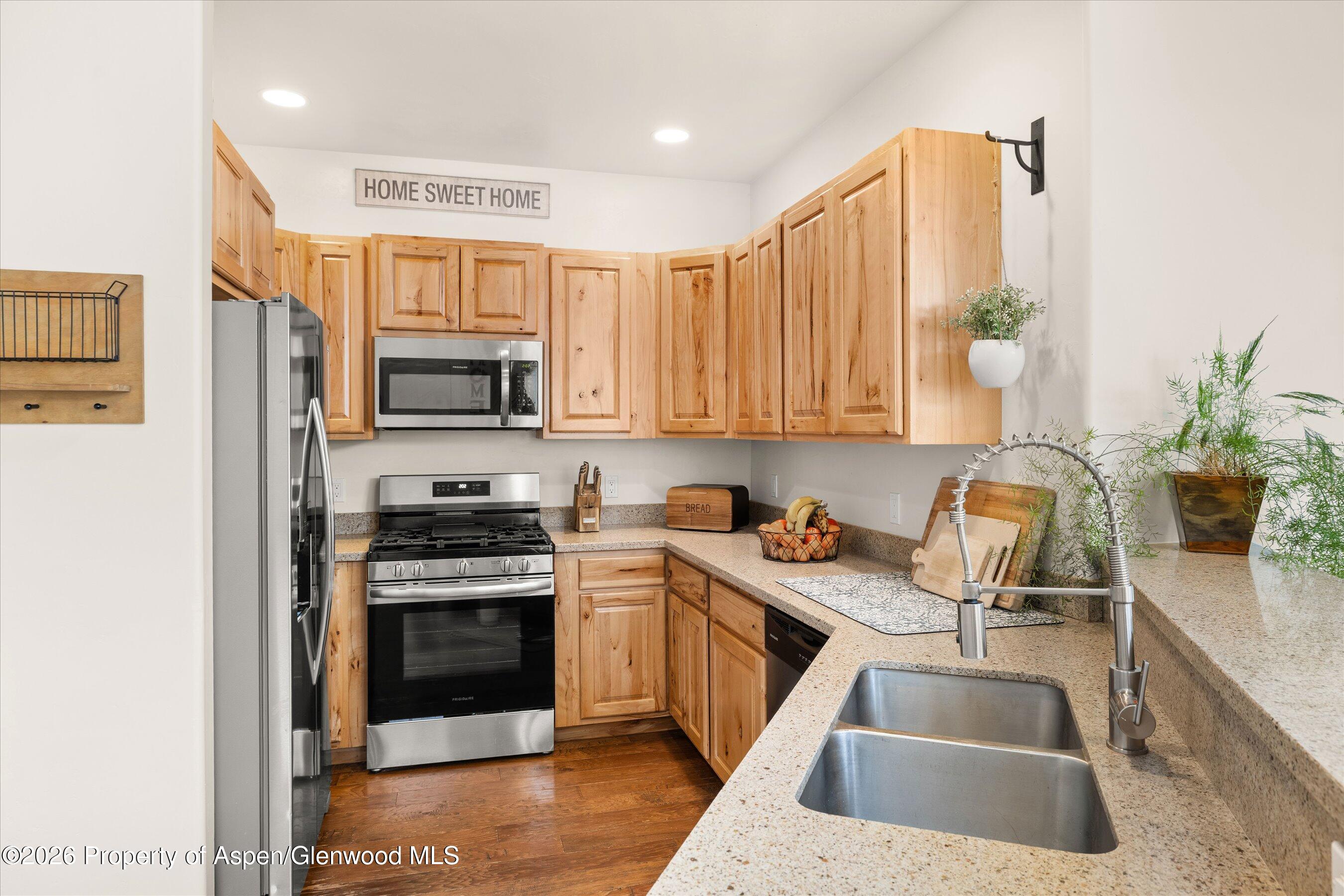 114 Redstone Drive New Castle, CO 81647 - Photo 6 of 20 a kitchen with stainless steel appliances granite countertop a sink stove and refrigerator