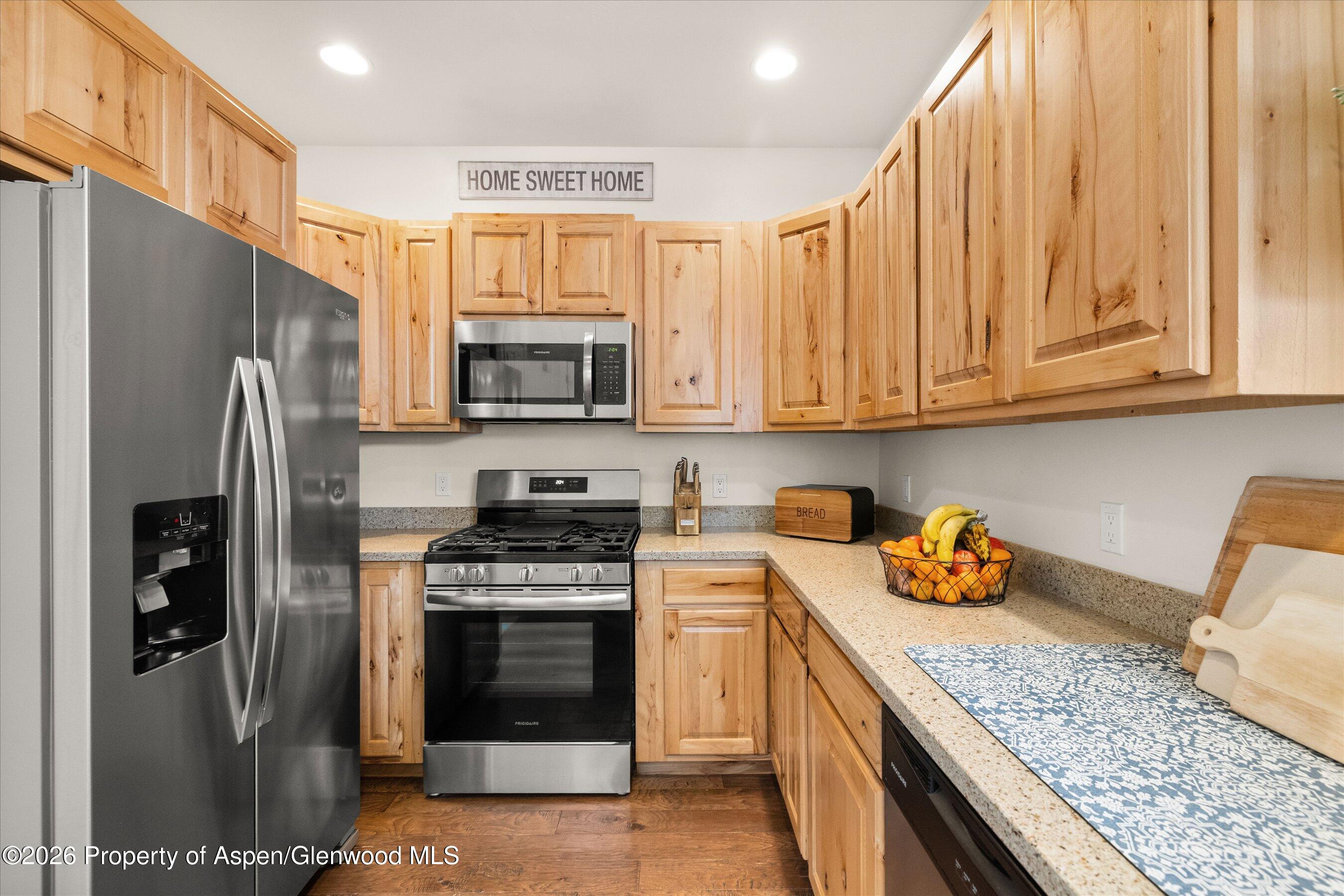 114 Redstone Drive New Castle, CO 81647 - Photo 7 of 20 a kitchen with stainless steel appliances granite countertop a refrigerator stove and sink