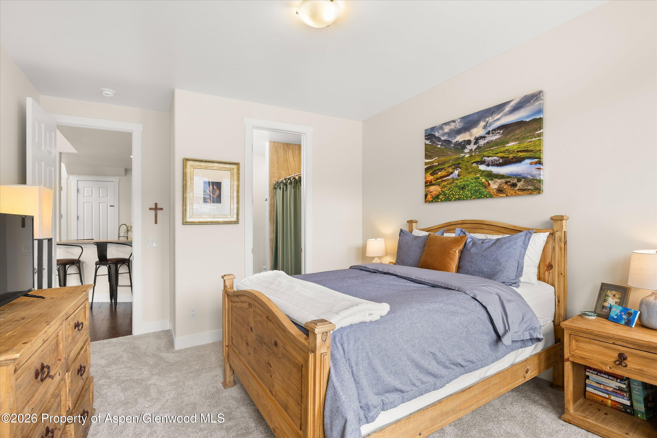 114 Redstone Drive New Castle, CO 81647 - Photo 8 of 20 a bed room with a bed and a painting on the wall