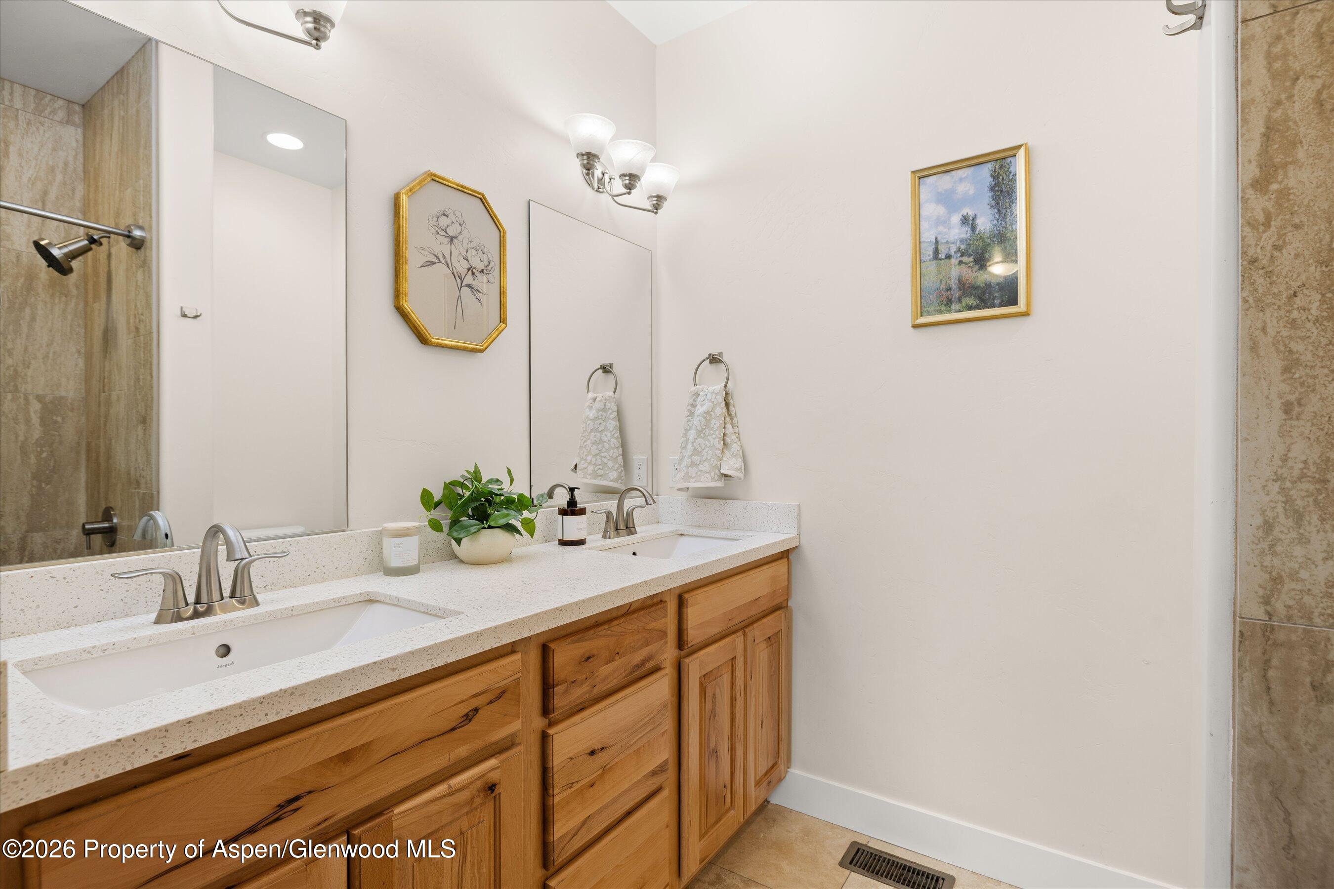 114 Redstone Drive New Castle, CO 81647 - Photo 9 of 20 a bathroom with a double vanity sink and a mirror