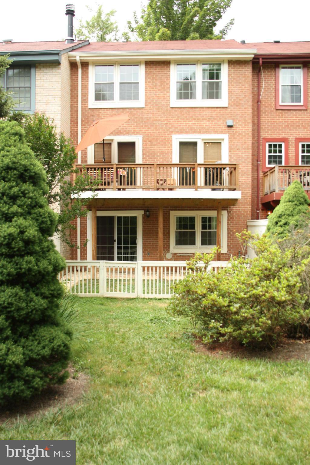 2108 Golf Course Drive Reston, VA 20191 - Photo 22 of 26 a large house with many windows and garden