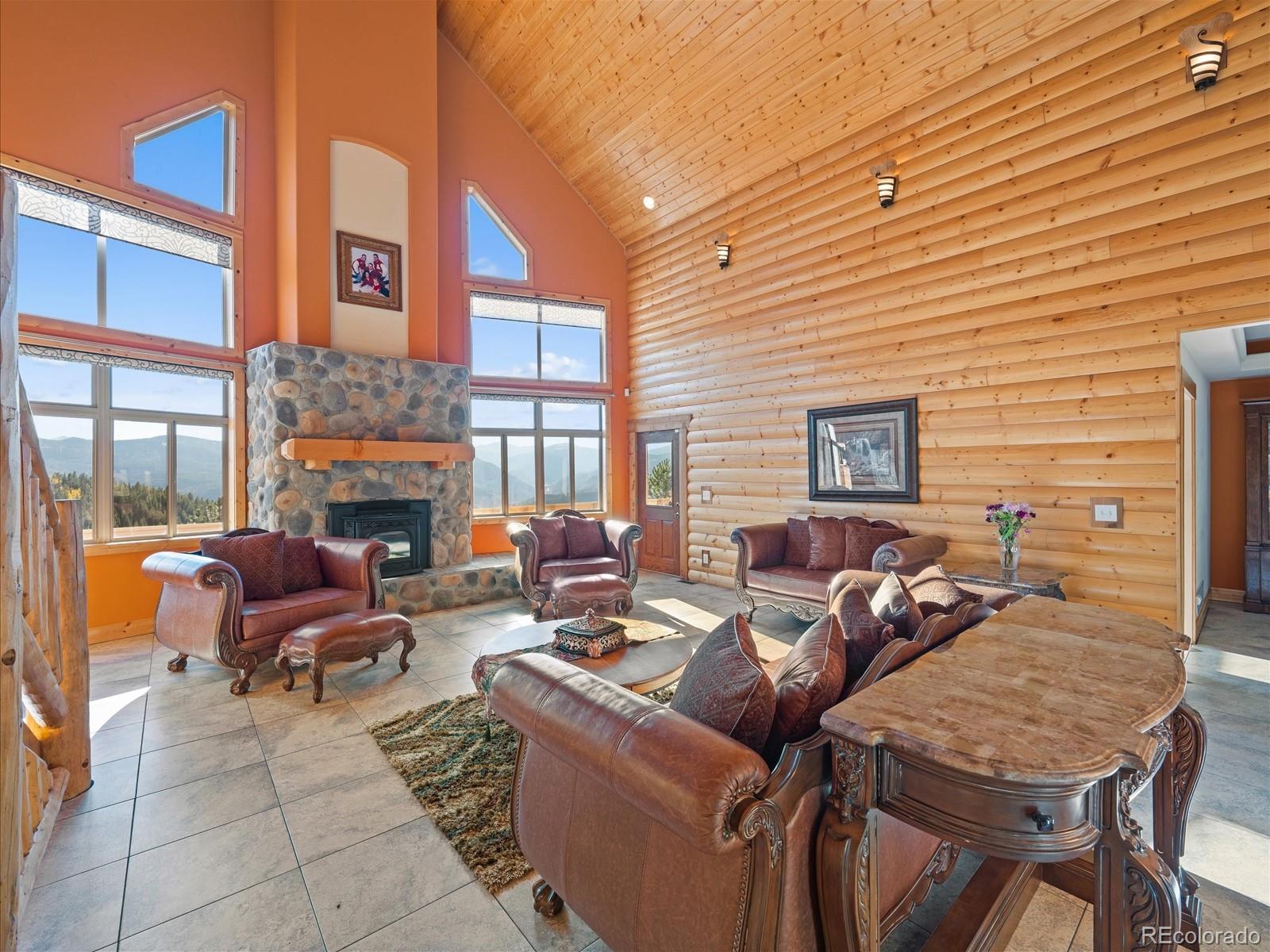 479 Dakota Ridge Road Idaho Springs, CO 80452 - Photo 14 of 50 a view of a patio with couches and a fireplace