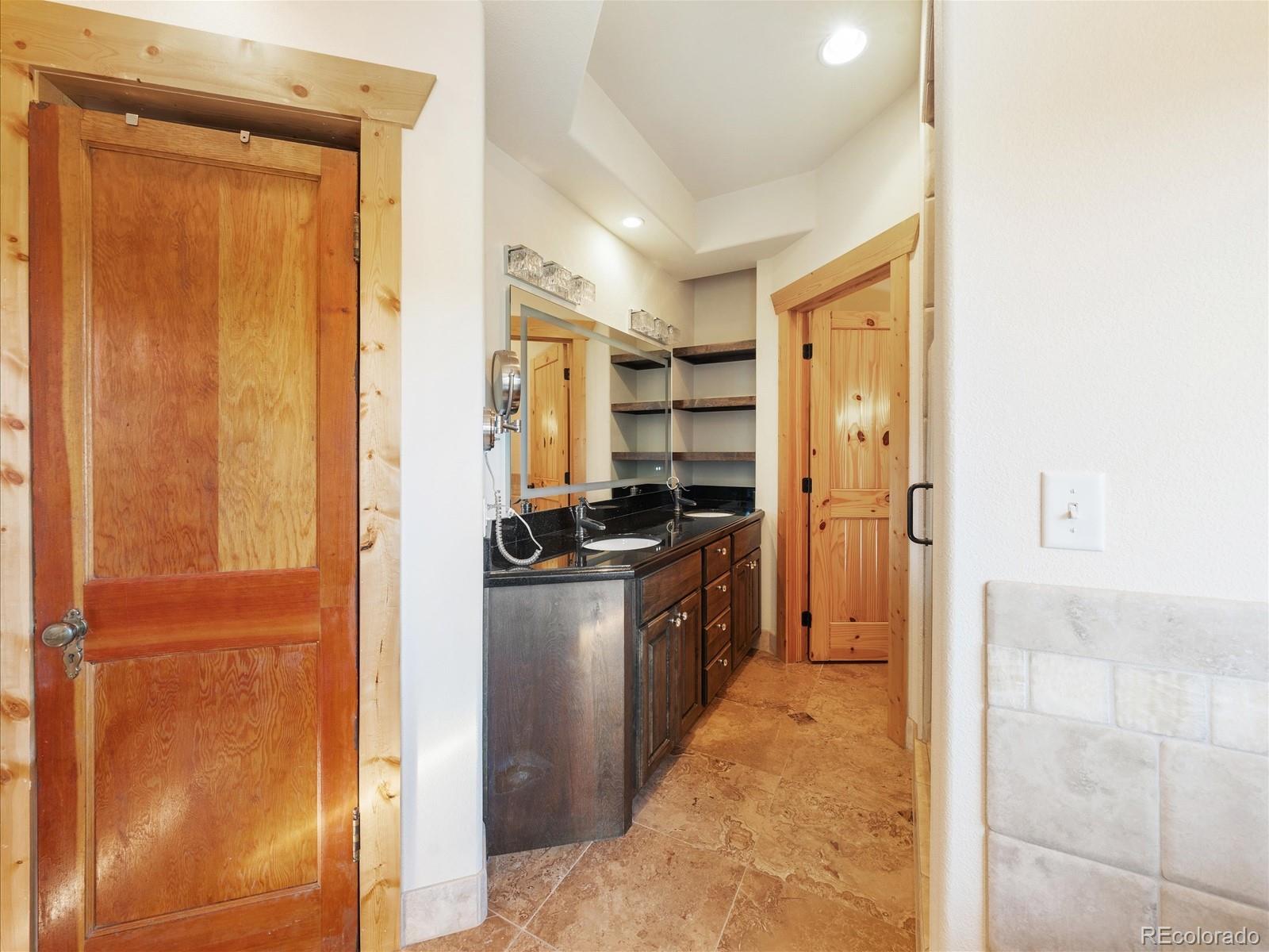 479 Dakota Ridge Road Idaho Springs, CO 80452 - Photo 20 of 50 a kitchen with stainless steel appliances granite countertop a refrigerator and a sink