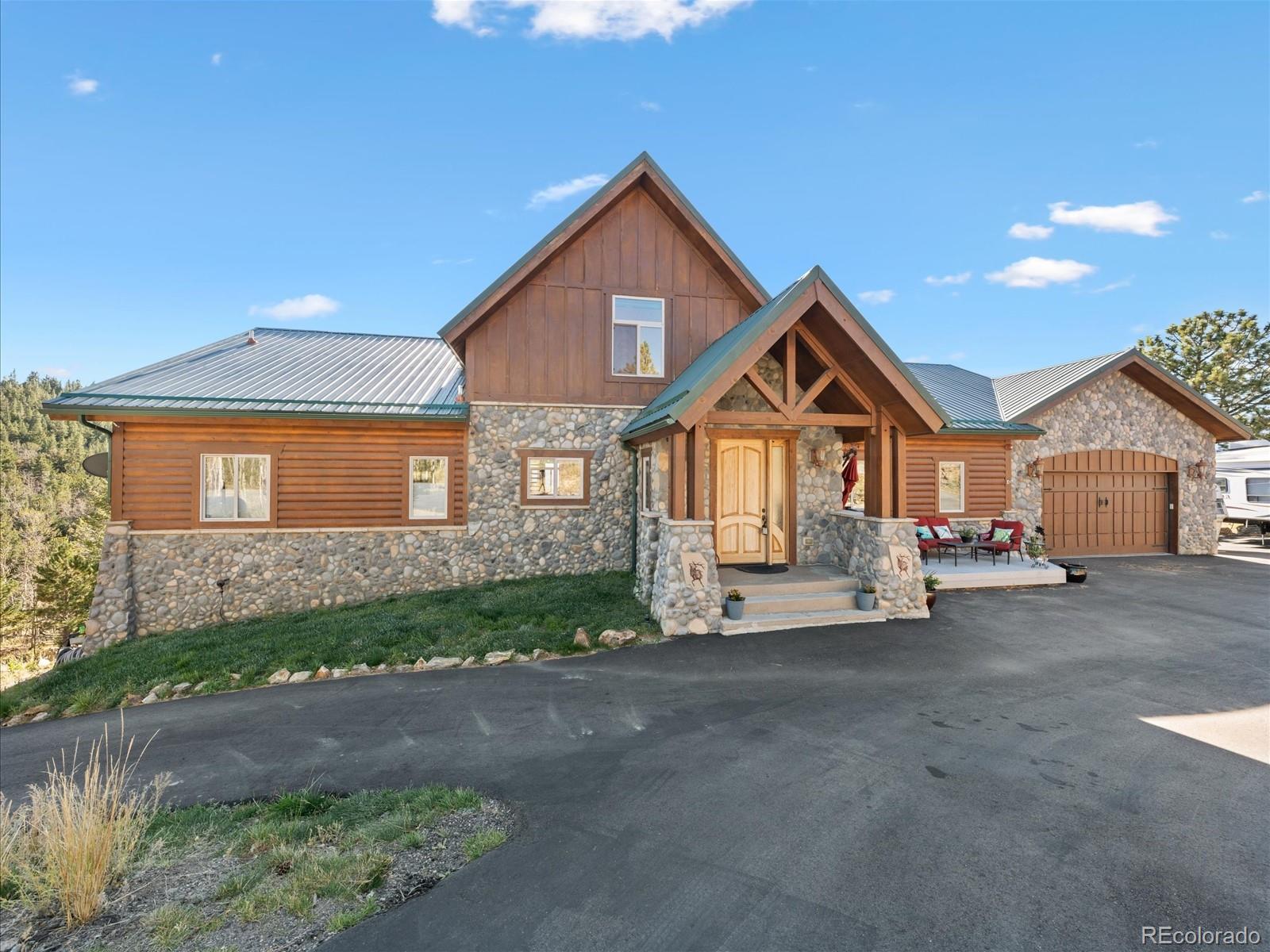 479 Dakota Ridge Road Idaho Springs, CO 80452 - Photo 2 of 50 a front view of a house with a yard and garage