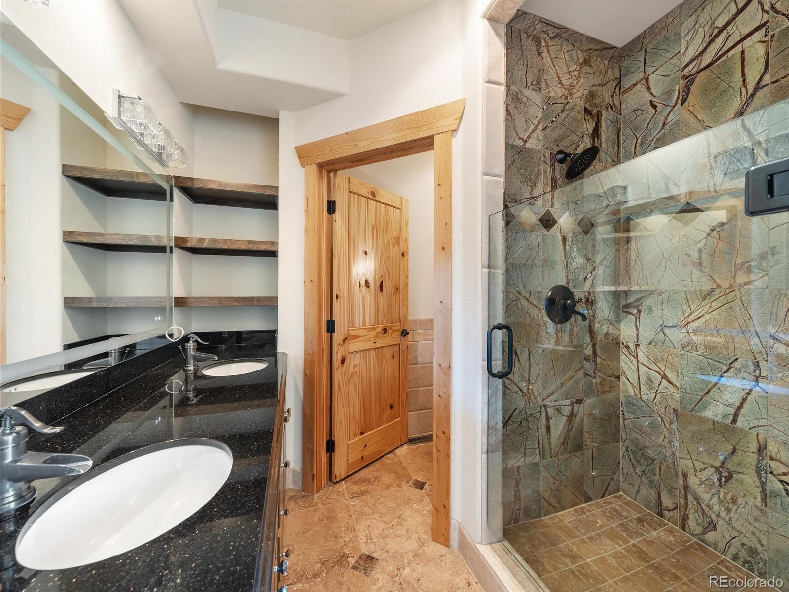 479 Dakota Ridge Road Idaho Springs, CO 80452 - Photo 21 of 50 a bathroom with a sink toilet and shower